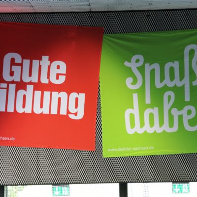 Zu sehen sind zwei Banner. Auf einem roten steht weiß: "Gute Bildung". Daneben ein grünes Banner, dort steht: "Spaß dabei".